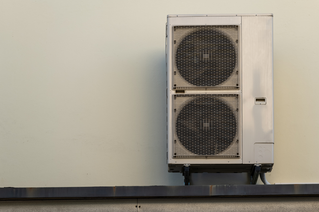 a heat pump on a house wall a heat pump on a house wall