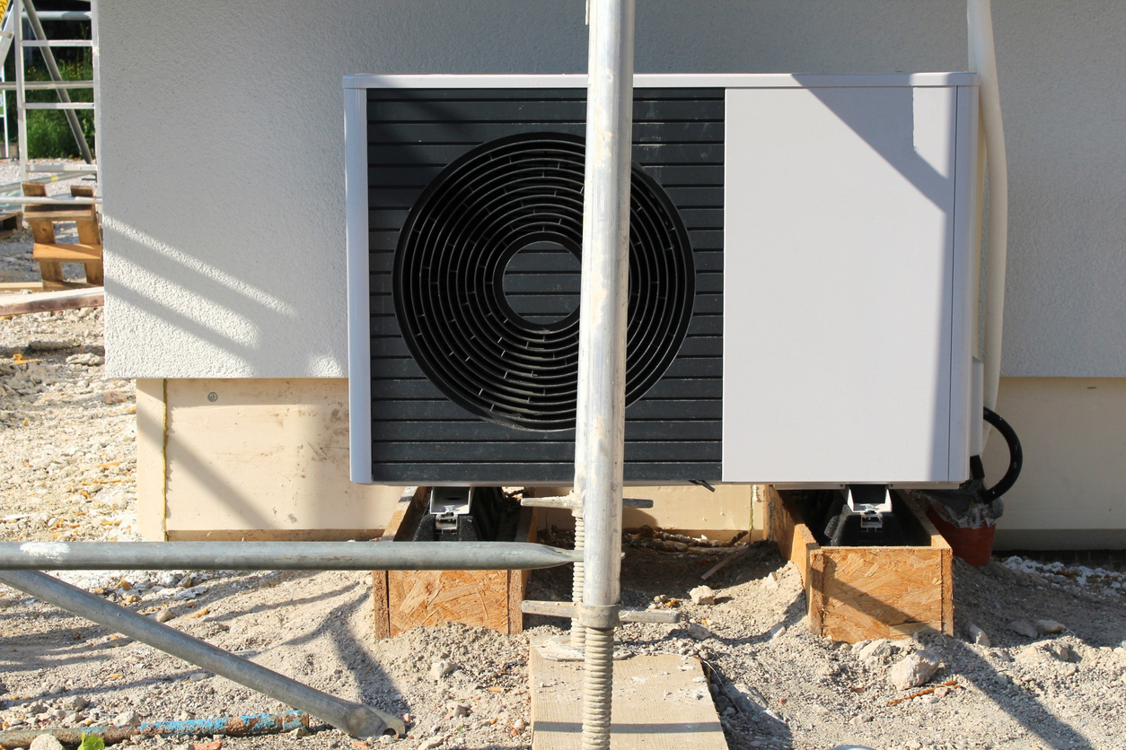 A heat pump is installed on a new building. Heat pumps are to replace heating with oil and gas in the future. A climate-friendly technology. A heat pump is installed on a new building. Heat pumps are to replace heating with oil and gas in the future. A climate-friendly technology.